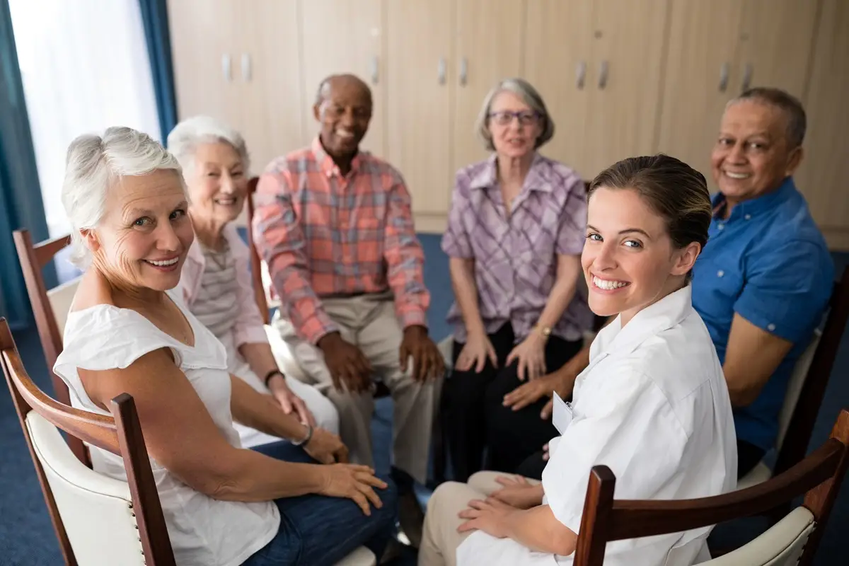 portrait of smiling female doctor sitting with seniors.